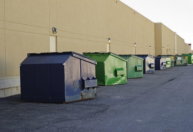 a truck unloading construction waste into a dumpster in East Point, GA